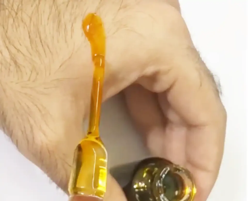 Applying pure Dehnul Oud Hindi oil on wrist — Al Shaikh Perfume